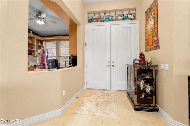 foyer entrance with vaulted ceiling and ceiling fan