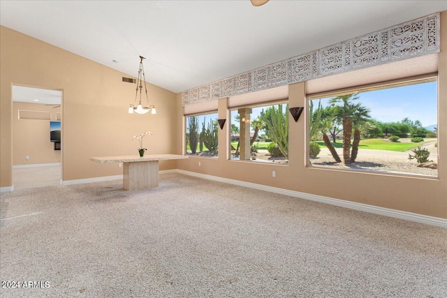 spare room featuring carpet flooring, a chandelier, and vaulted ceiling