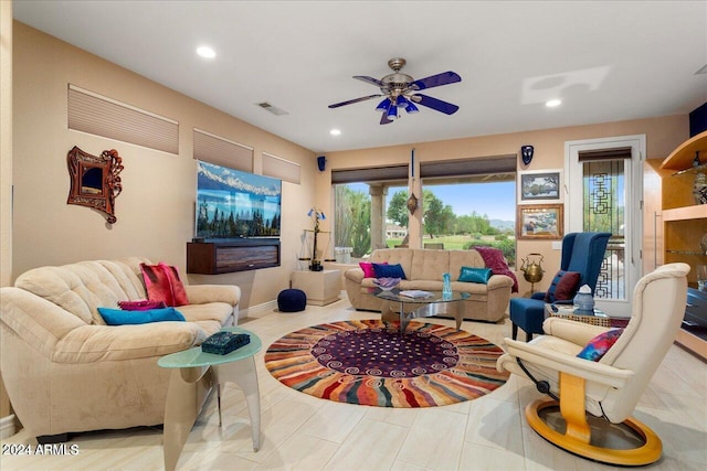 living room with ceiling fan and light tile patterned floors