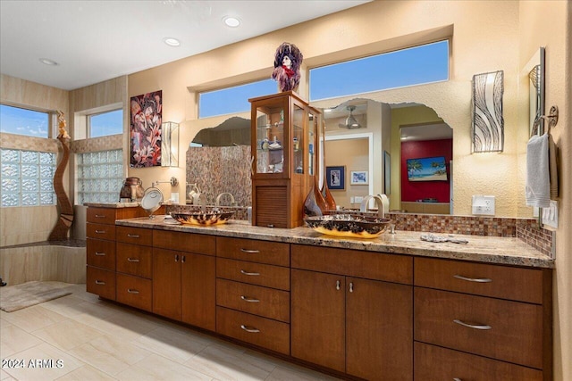 bathroom with vanity and decorative backsplash