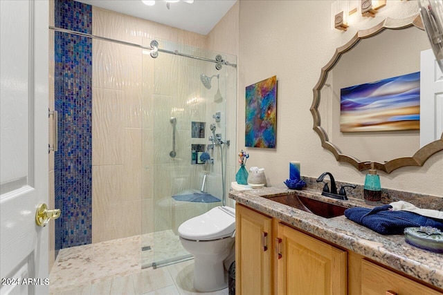 bathroom featuring a tile shower, vanity, tile patterned flooring, and toilet