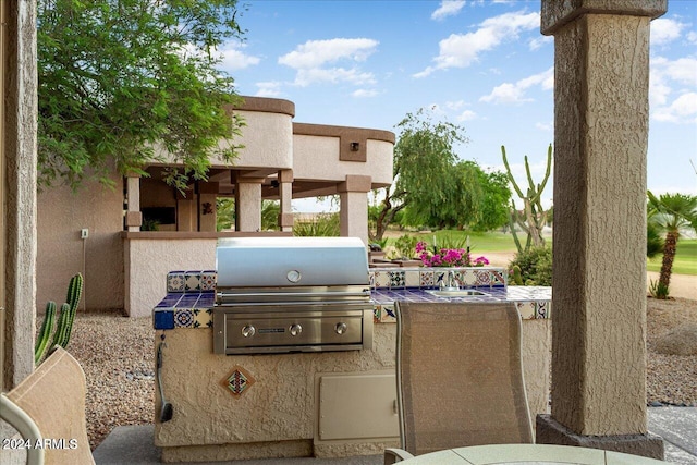 view of patio with area for grilling and exterior kitchen