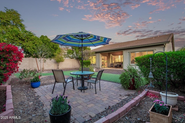 view of patio terrace at dusk