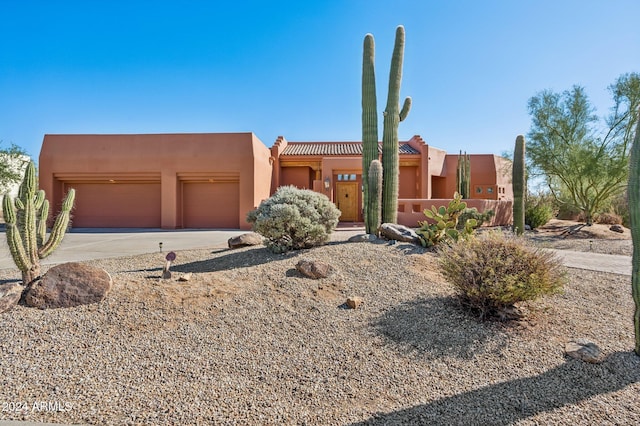 southwest-style home featuring a garage