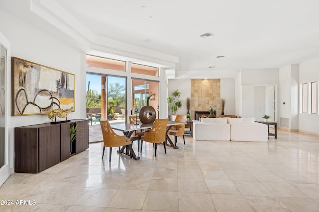 tiled dining area with a fireplace