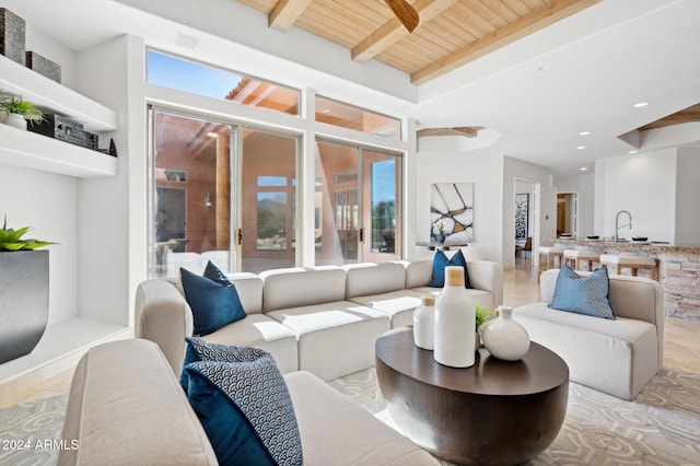 living room with beam ceiling, wood ceiling, sink, and light tile patterned floors