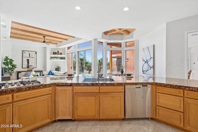 kitchen featuring stainless steel appliances, ceiling fan, sink, light tile patterned floors, and beamed ceiling