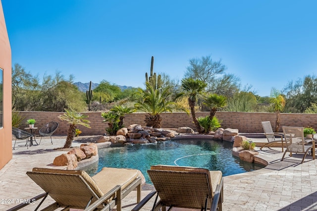 view of pool with pool water feature and a patio