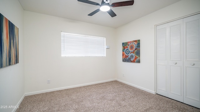 unfurnished bedroom featuring a closet, baseboards, carpet, and a ceiling fan