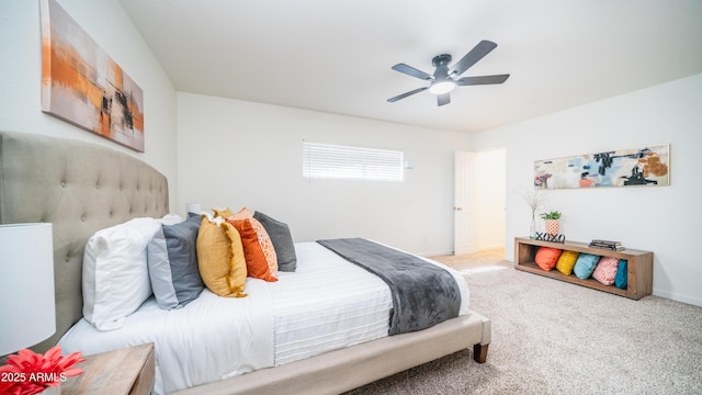 carpeted bedroom featuring baseboards and ceiling fan