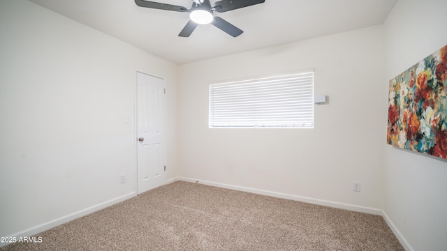 carpeted empty room with baseboards and ceiling fan