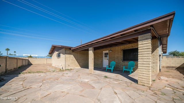 back of house with a patio area and a fenced backyard