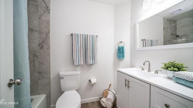 full bathroom featuring visible vents, toilet, shower / tub combo with curtain, wood finished floors, and vanity