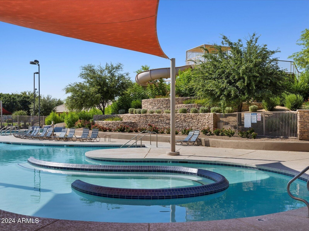 view of pool with a hot tub and a patio area