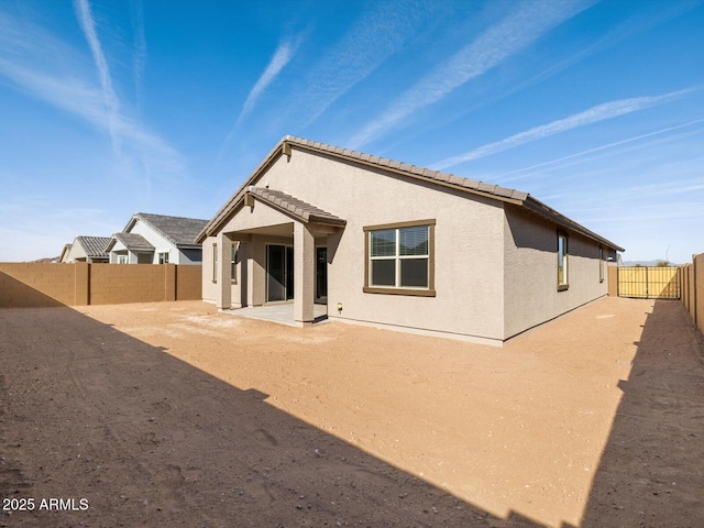 back of house with a patio