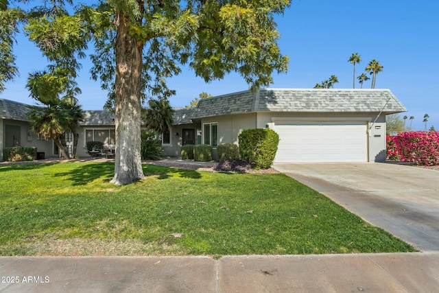 single story home with a garage and a front lawn