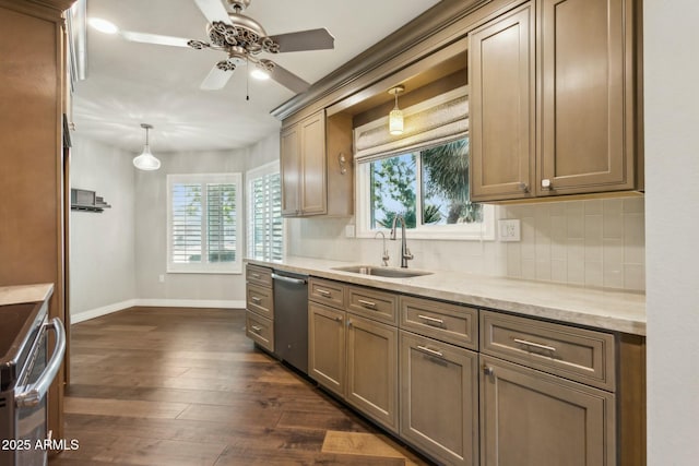 kitchen with appliances with stainless steel finishes, sink, backsplash, and decorative light fixtures