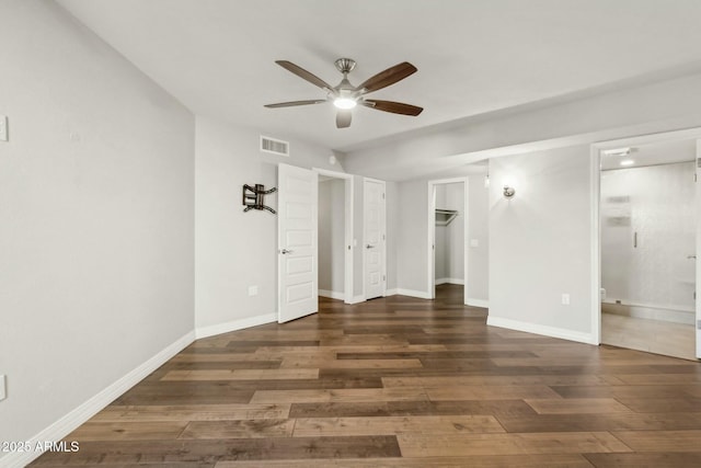 unfurnished room featuring dark wood-type flooring and ceiling fan