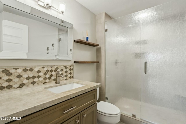 bathroom featuring vanity, toilet, an enclosed shower, and backsplash