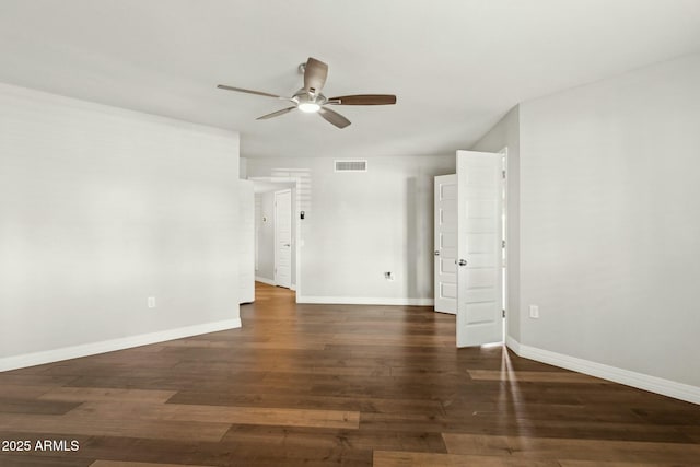 empty room featuring dark hardwood / wood-style flooring and ceiling fan