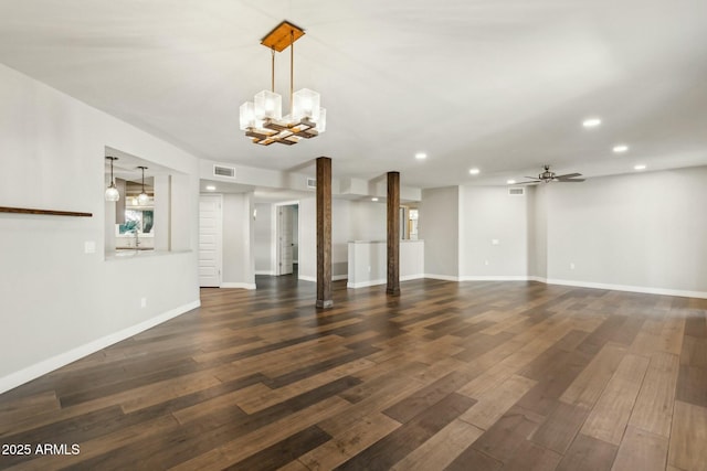 unfurnished living room with dark hardwood / wood-style flooring and ceiling fan with notable chandelier