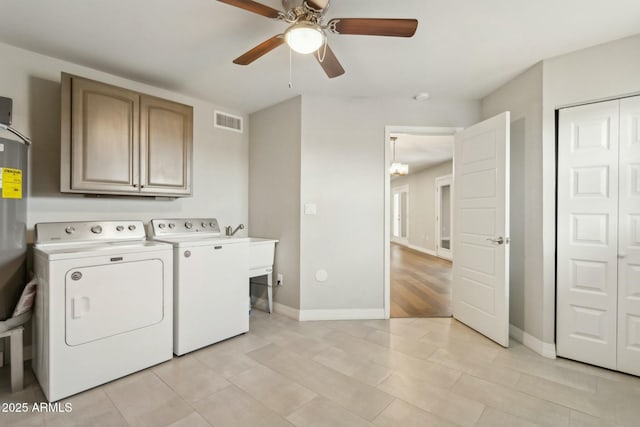 clothes washing area featuring ceiling fan, cabinets, and washer and clothes dryer