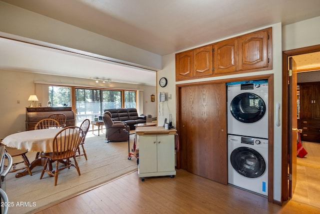 11 N County Road N1030 St, Greer, AZ 85927 - kitchen featuring stacked washing machine and dryer, wood finished floors, brown cabinetry, open floor plan, and light countertops