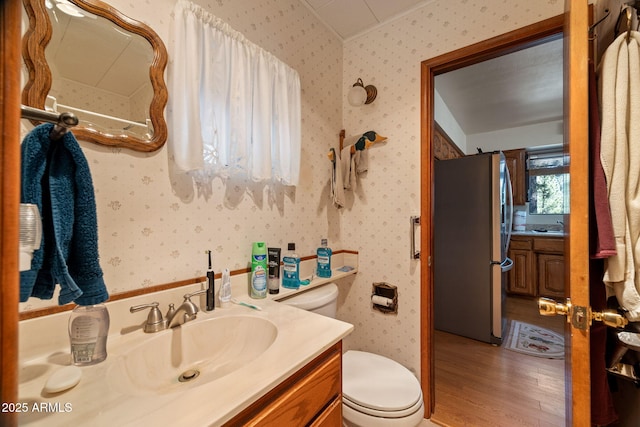 11 N County Road N1030 St, Greer, AZ 85927 - bathroom with toilet, wood finished floors, vanity, and wallpapered walls