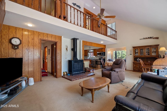 11 N County Road N1030 St, Greer, AZ 85927 - living area with light colored carpet, a wood stove, high vaulted ceiling, ceiling fan, and wood walls
