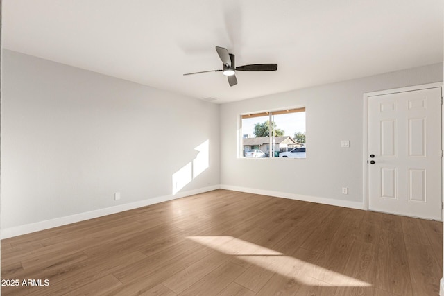 empty room with hardwood / wood-style flooring and ceiling fan