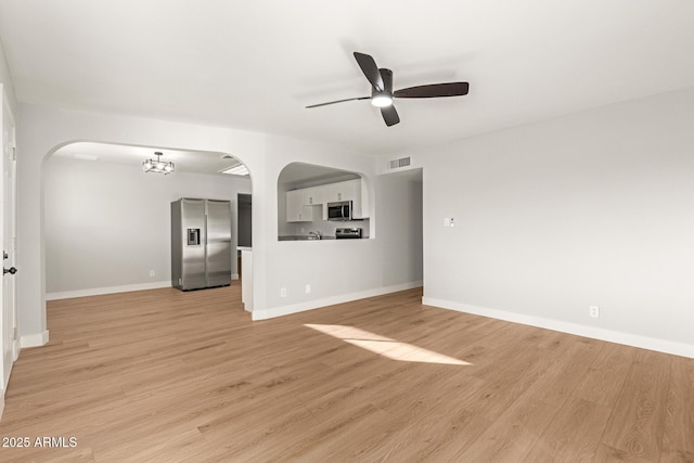 unfurnished living room with ceiling fan and light hardwood / wood-style flooring