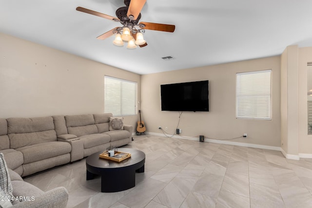 tiled living room featuring ceiling fan