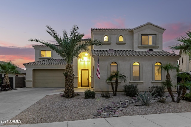 mediterranean / spanish-style house with a garage