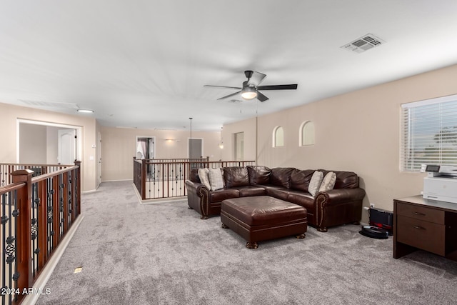 carpeted living room with ceiling fan