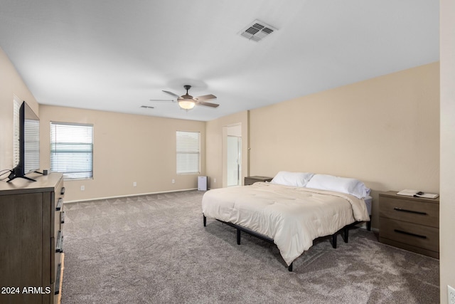 bedroom featuring dark colored carpet and ceiling fan