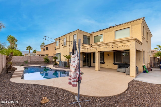 view of swimming pool with a patio and central air condition unit