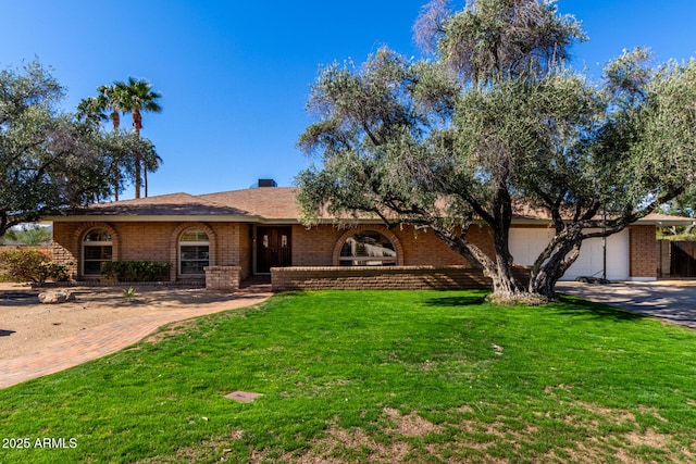 single story home with an attached garage, brick siding, concrete driveway, a front lawn, and a chimney