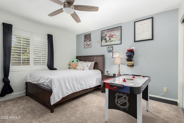 bedroom with light colored carpet, ceiling fan, and baseboards