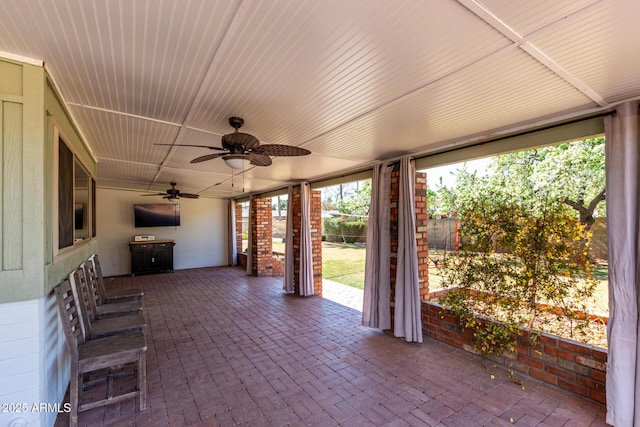 view of patio with ceiling fan and fence