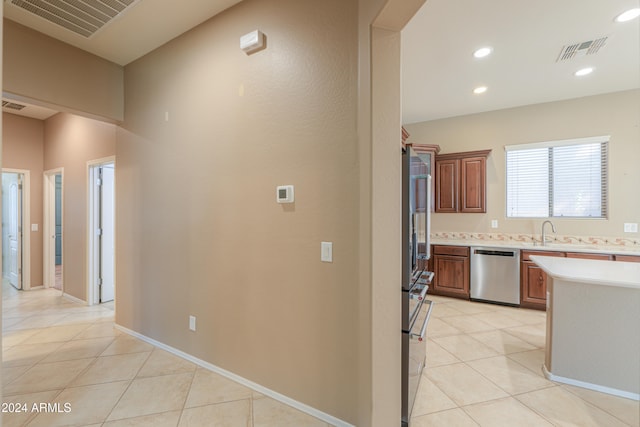 kitchen featuring sink, stainless steel appliances, and light tile patterned floors