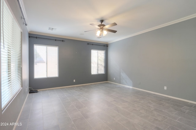 unfurnished room featuring ceiling fan and ornamental molding