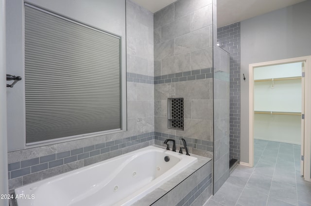 bathroom featuring tile patterned flooring and shower with separate bathtub