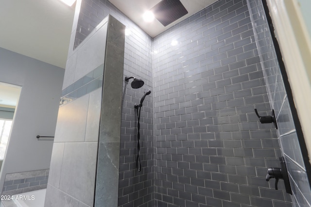 bathroom with a tile shower and vaulted ceiling