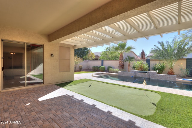 view of patio / terrace featuring pool water feature and a pool with hot tub