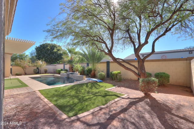 view of yard with a fenced in pool