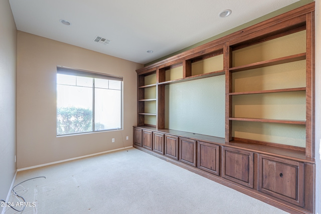 unfurnished living room featuring light carpet