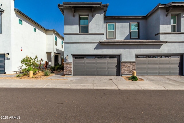 1829 N 43rd Ter, Phoenix, AZ 85008 - view of front facade with a garage, stucco siding, driveway, and stone siding
