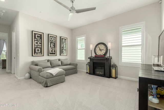 1829 N 43rd Ter, Phoenix, AZ 85008 - carpeted living area featuring a glass covered fireplace, baseboards, and a ceiling fan