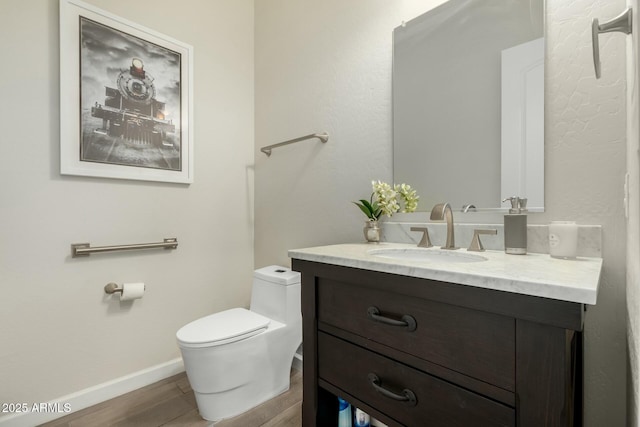 1829 N 43rd Ter, Phoenix, AZ 85008 - bathroom with vanity, baseboards, wood finished floors, and toilet