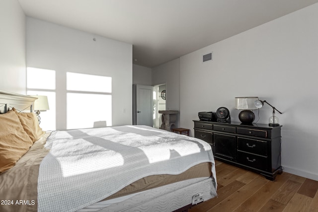 bedroom with dark hardwood / wood-style flooring